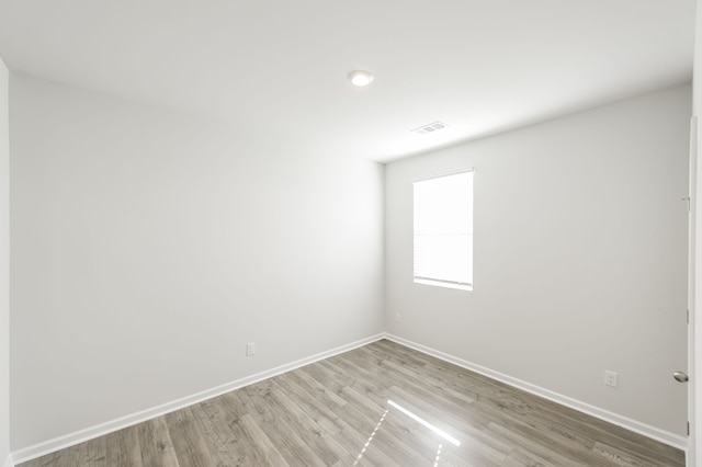 spare room with light hardwood / wood-style flooring