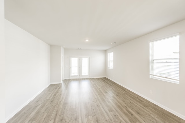 empty room with light hardwood / wood-style flooring