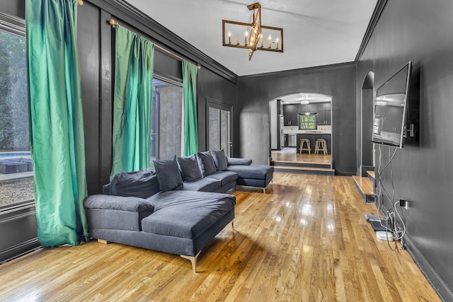 interior space featuring ornamental molding, light hardwood / wood-style floors, and a notable chandelier