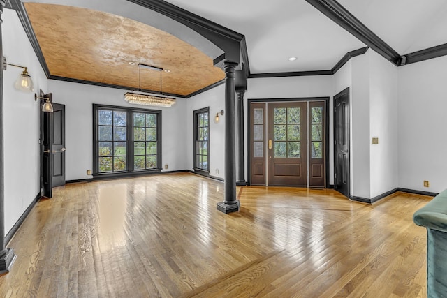 entryway with a healthy amount of sunlight, light wood-type flooring, and decorative columns