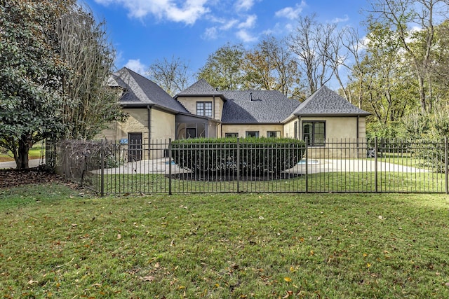 rear view of property featuring a yard