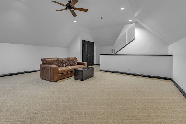 carpeted home theater featuring lofted ceiling and ceiling fan