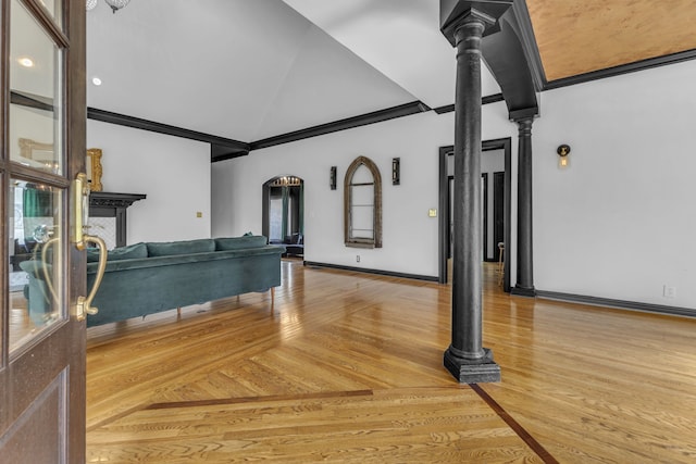 interior space with lofted ceiling, hardwood / wood-style flooring, and crown molding