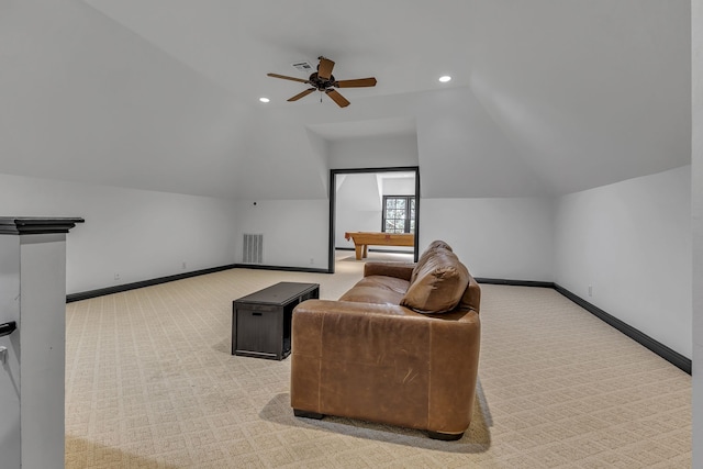 interior space featuring lofted ceiling, light carpet, and ceiling fan