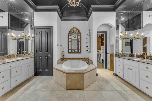 bathroom with ornamental molding, vanity, tile patterned floors, and a relaxing tiled tub