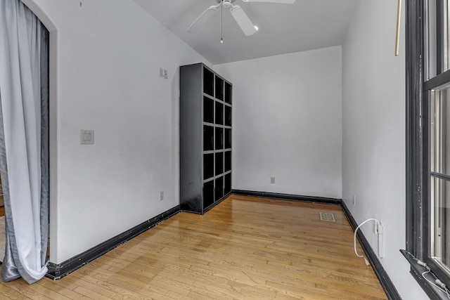 empty room with light hardwood / wood-style floors and ceiling fan