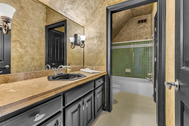 full bathroom featuring tile patterned flooring, vanity, toilet, and tiled shower / bath