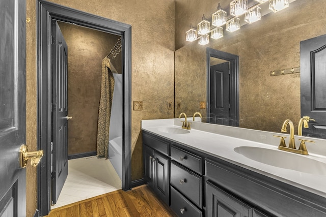 bathroom with vanity, hardwood / wood-style flooring, and tub / shower combination