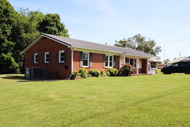 ranch-style house with a front lawn and central AC