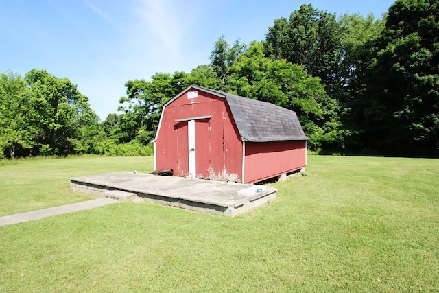 view of outbuilding featuring a lawn