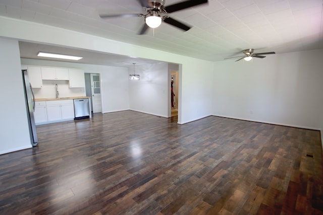 unfurnished living room with dark hardwood / wood-style flooring, ceiling fan, and sink