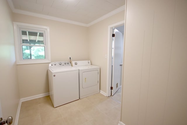 clothes washing area featuring washer and dryer, light tile patterned floors, and crown molding