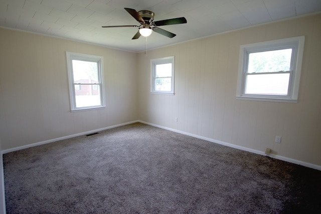 unfurnished room with ceiling fan, crown molding, a healthy amount of sunlight, and carpet floors