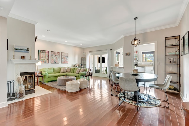 living room with ornamental molding, hardwood / wood-style floors, and french doors