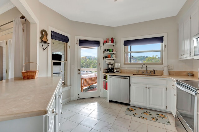 kitchen with white cabinets, a wealth of natural light, sink, and appliances with stainless steel finishes