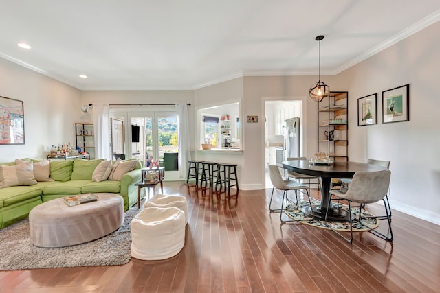 living room featuring wood-type flooring and crown molding