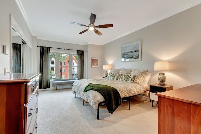 carpeted bedroom with ceiling fan and crown molding