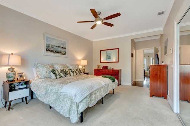 bedroom featuring carpet flooring, ornamental molding, and ceiling fan