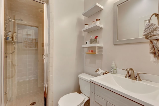 bathroom featuring vanity, toilet, and a shower with door