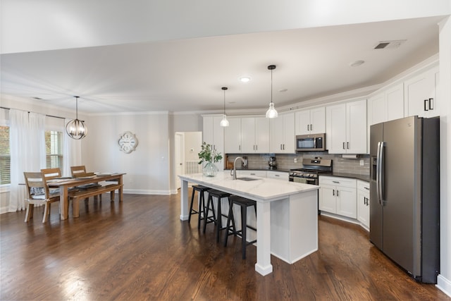 kitchen featuring pendant lighting, white cabinets, sink, and stainless steel appliances