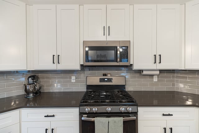 kitchen with white cabinets, decorative backsplash, and appliances with stainless steel finishes