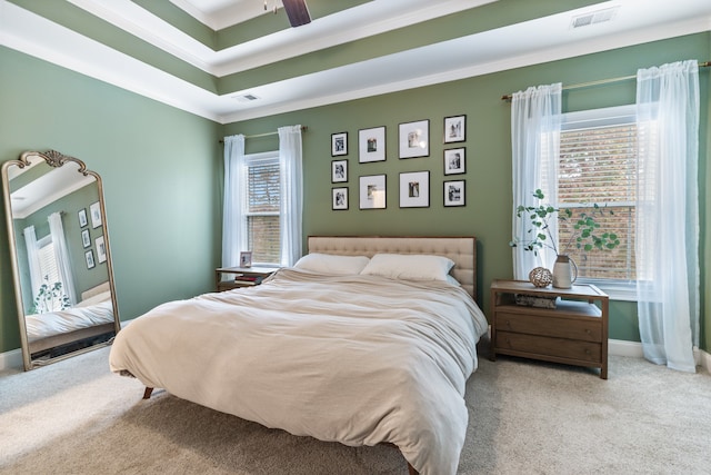 carpeted bedroom with ceiling fan, multiple windows, and crown molding