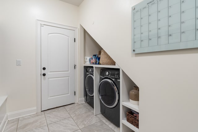 clothes washing area with separate washer and dryer