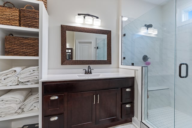 bathroom featuring vanity and a shower with shower door