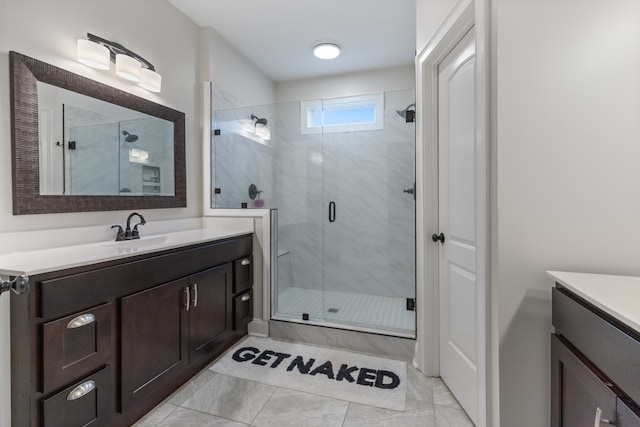 bathroom featuring vanity and a shower with door