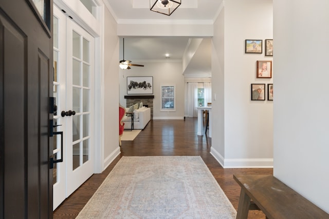 hallway featuring dark wood-type flooring and crown molding