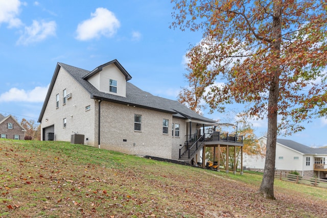 view of home's exterior with a garage and a wooden deck