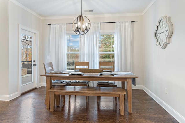 dining room with dark wood-type flooring, a chandelier, and ornamental molding