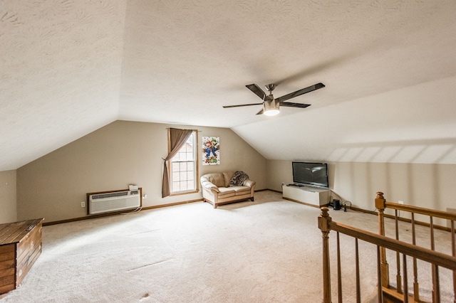 additional living space with carpet floors, ceiling fan, vaulted ceiling, and a wall mounted air conditioner