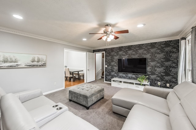 carpeted living room featuring ornamental molding, a textured ceiling, and ceiling fan