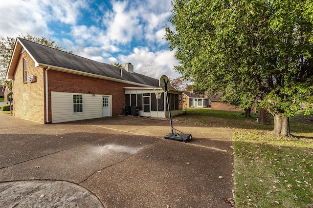 back of property with a sunroom