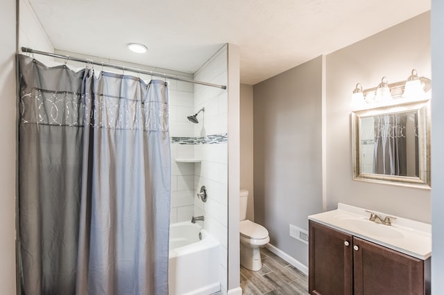 full bathroom featuring shower / bath combo, wood-type flooring, toilet, a textured ceiling, and vanity