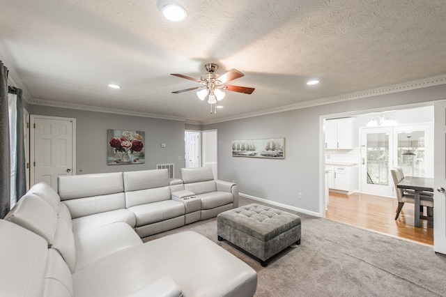 living room with hardwood / wood-style floors, a textured ceiling, ceiling fan, and crown molding