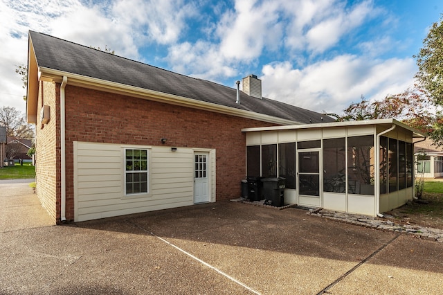 back of house featuring a sunroom