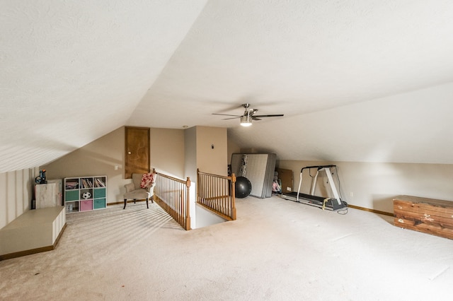 additional living space featuring carpet floors, a textured ceiling, lofted ceiling, and ceiling fan