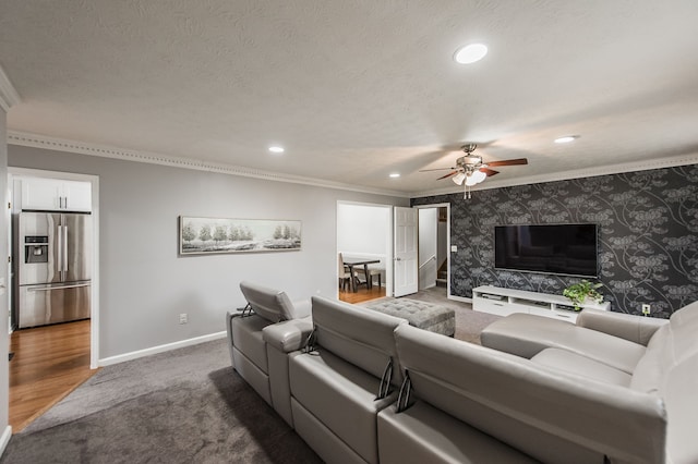 living room with ornamental molding, a textured ceiling, and ceiling fan