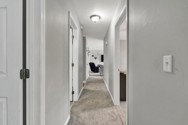 hall featuring light colored carpet