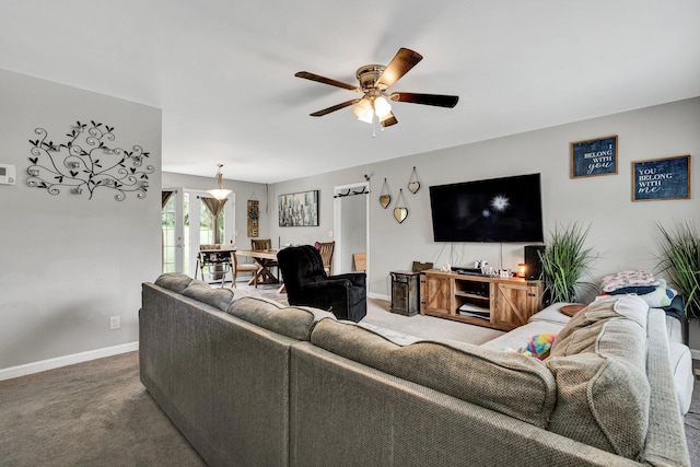 carpeted living room with ceiling fan