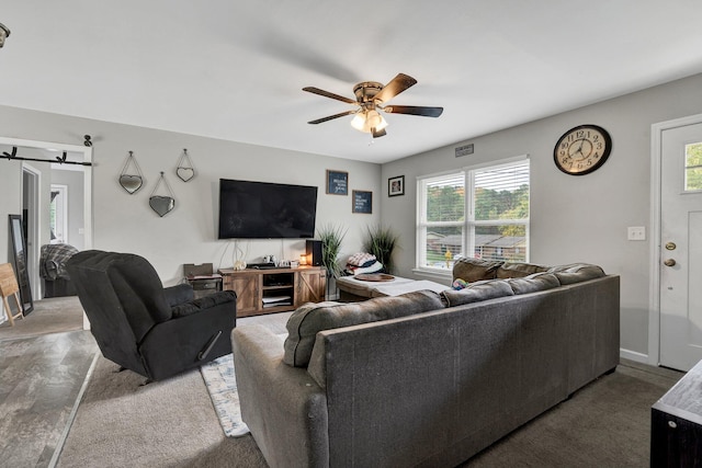 living room featuring a barn door, plenty of natural light, and ceiling fan