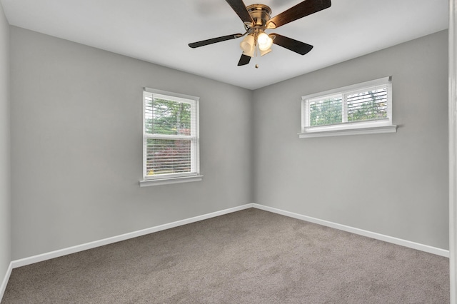 carpeted spare room featuring ceiling fan