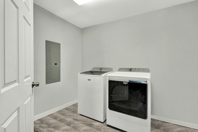 laundry area featuring electric panel and washing machine and dryer