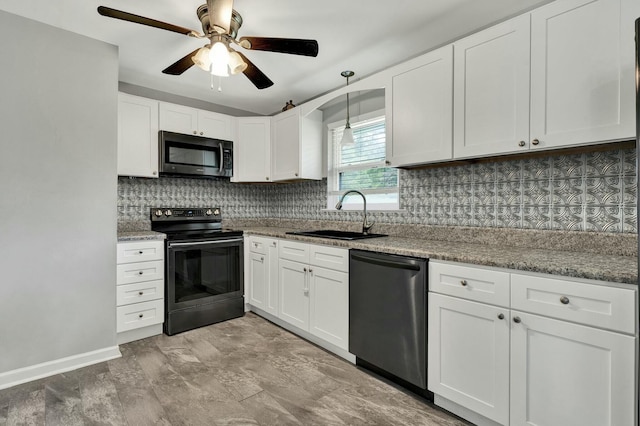 kitchen with white cabinetry, sink, light stone countertops, tasteful backsplash, and appliances with stainless steel finishes