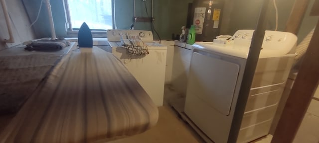 laundry area featuring water heater and independent washer and dryer