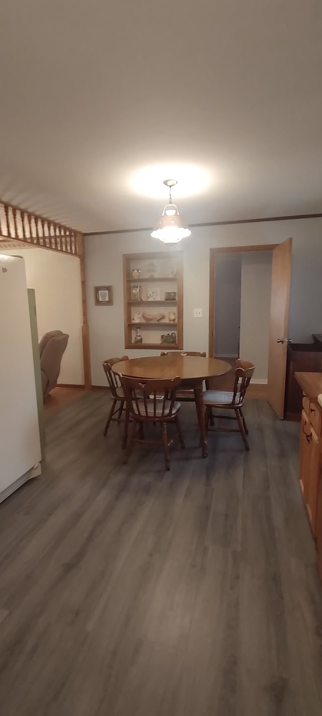 dining space featuring dark wood-type flooring