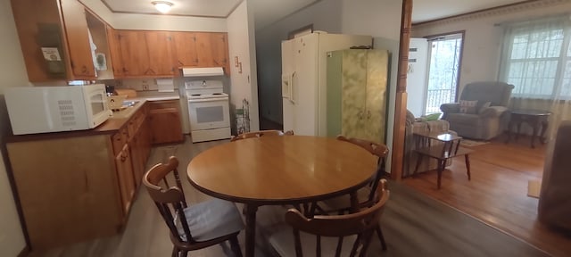 kitchen featuring white appliances and hardwood / wood-style floors