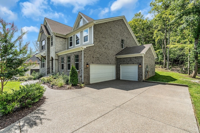 view of side of property with a garage and a lawn